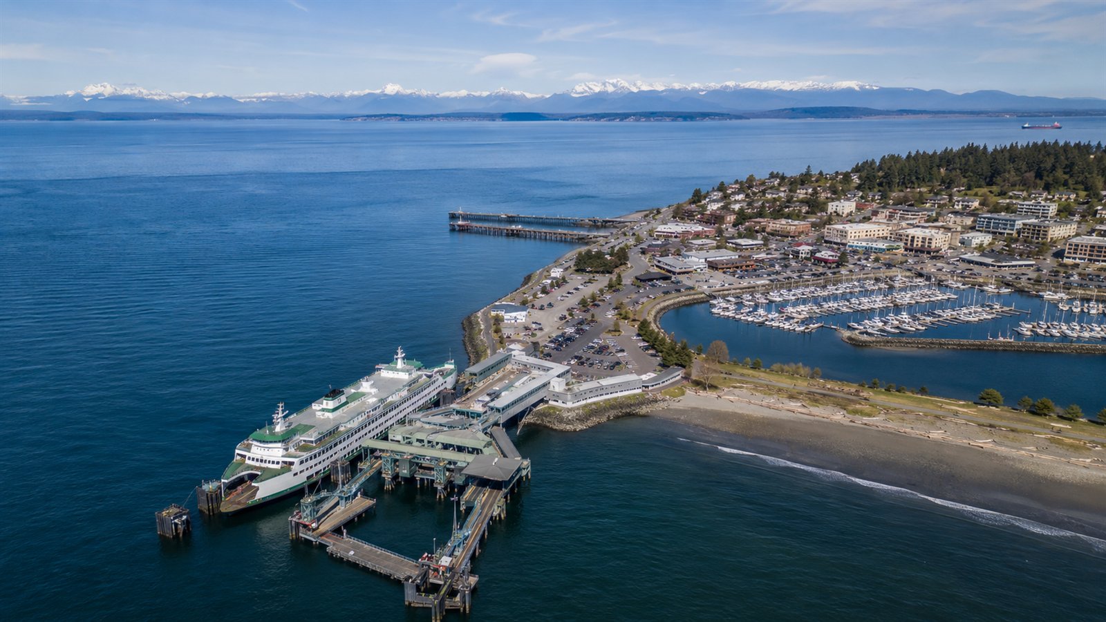 Aerial drone view of the Edmonds waterfront, ferry and marina with the Olympic Mountains